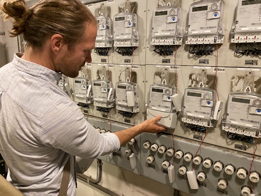 David Nordström framför de nya elmätarna på den gamla mätartavlan